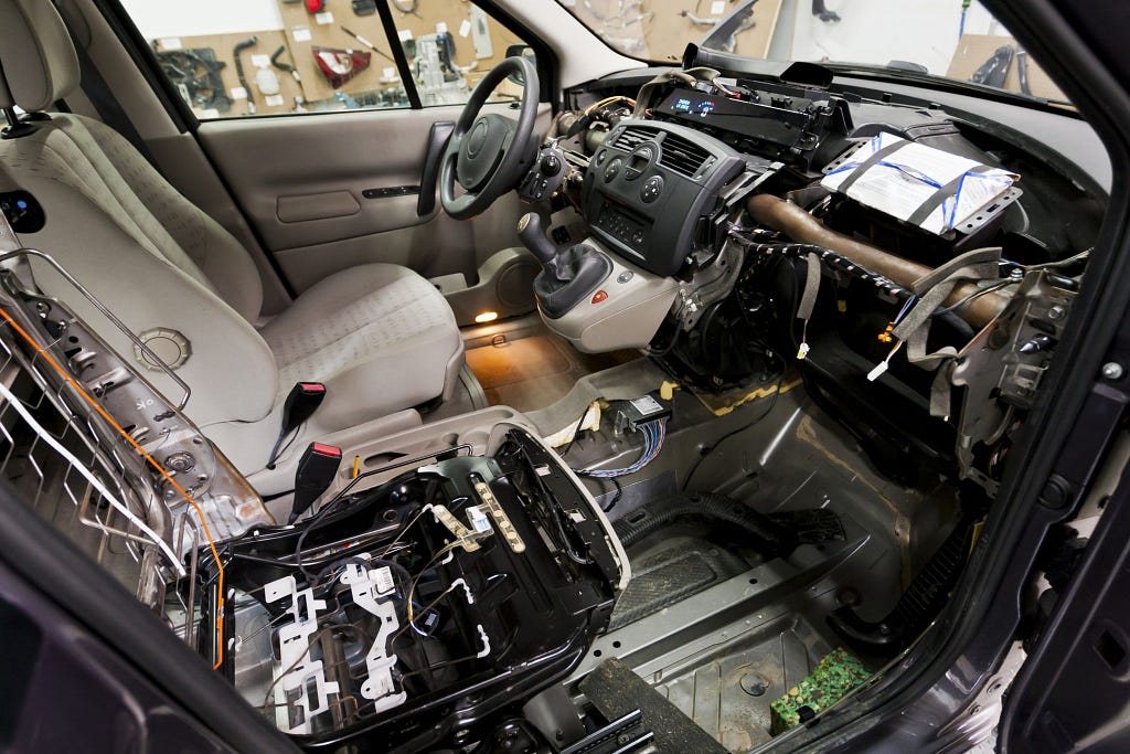 A car is shown with electrical parts open ready for electrical car repair