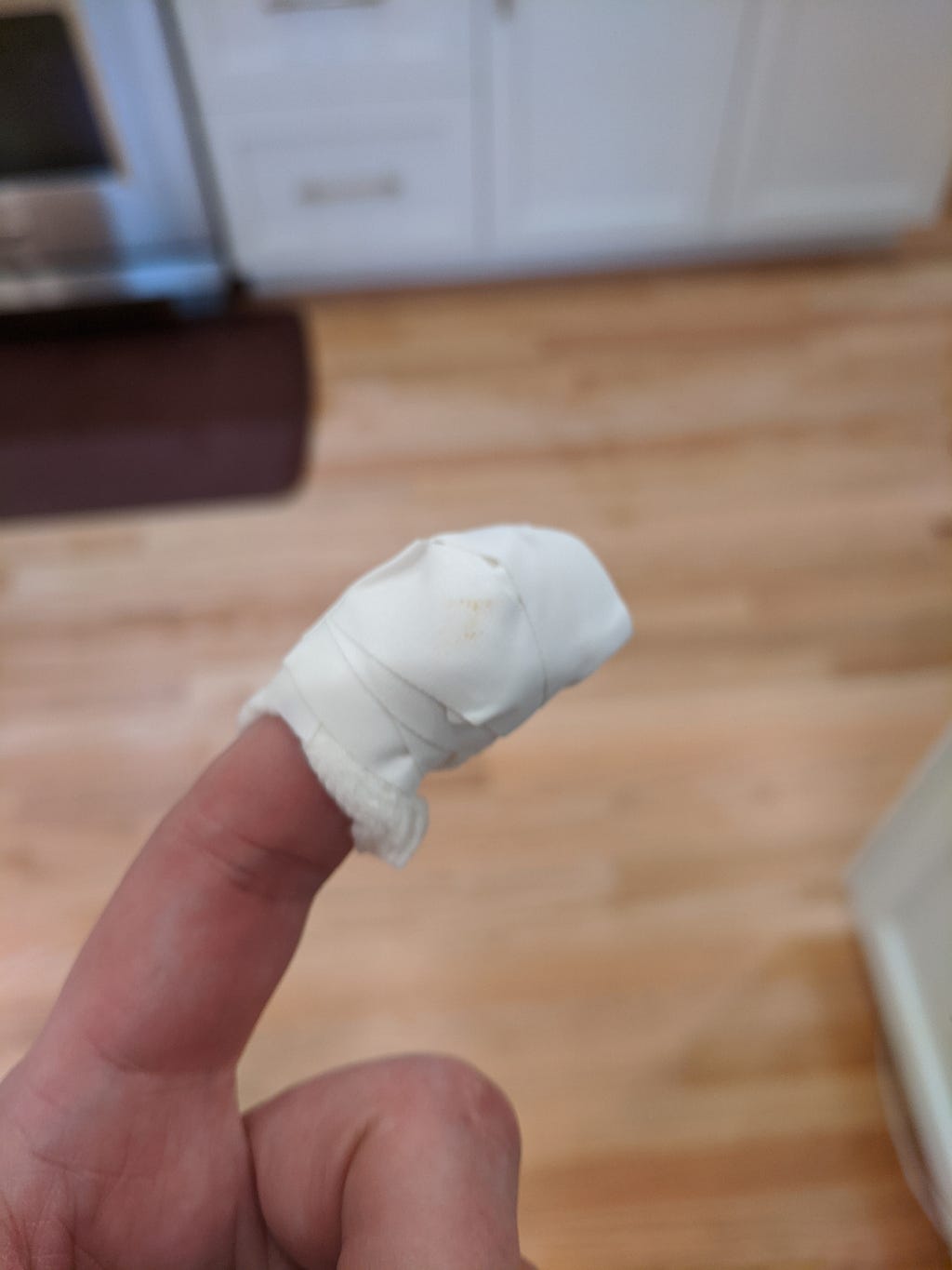 The author’s bandaged left index finger, with a smudge that might be blood on the bandage.