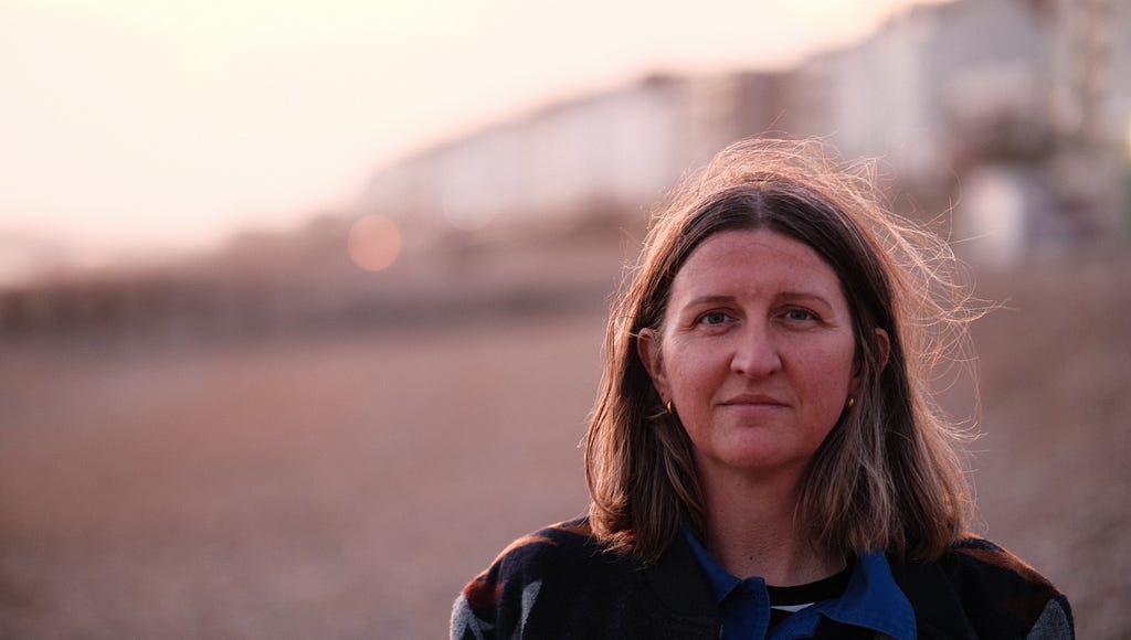 A portrait of Rebecca Goss at the seaside