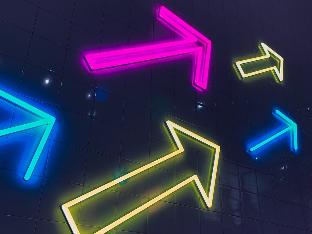 A collection of neon arrows pointing to the right.