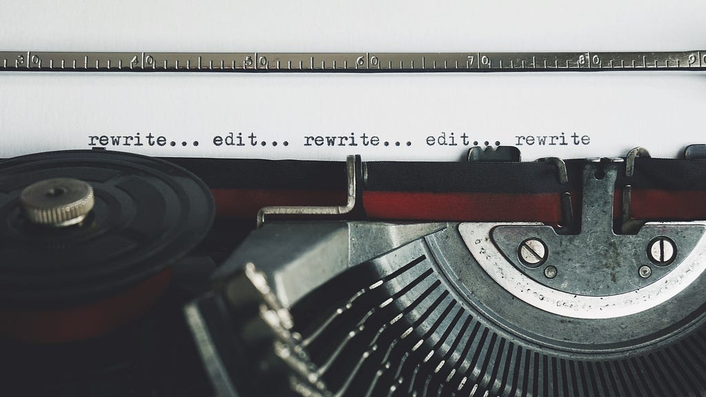 typewriter close up, letters reading rewrite… edit… rewrite… edit… rewrite