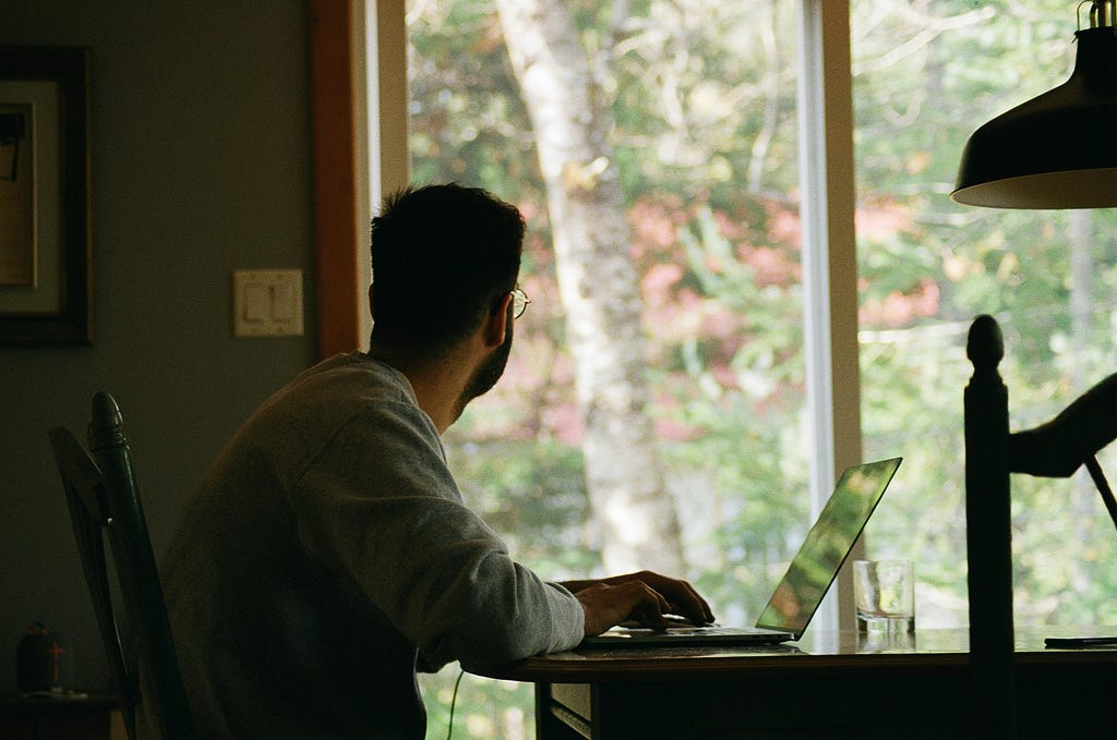 Person working at desk looking out of the window