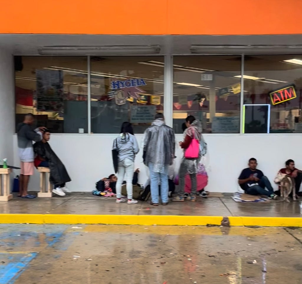 Migrants at a gas station.