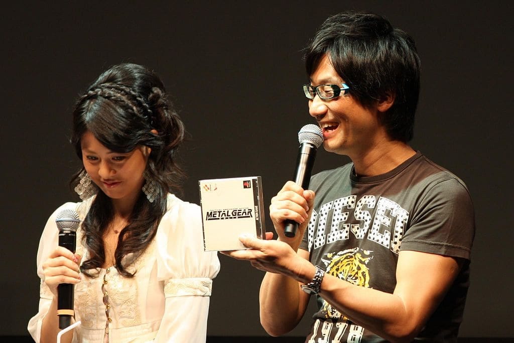 Hideo Kojima showing a PS1 copy of Metal Gear Solid