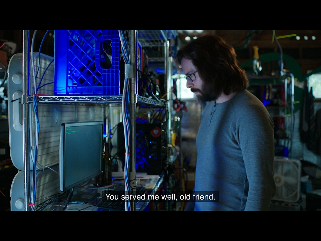 The Gilfoyle character from the HBO series staring at a computer monitor in a homespun ‘datacentre’ (actually running in a garage)