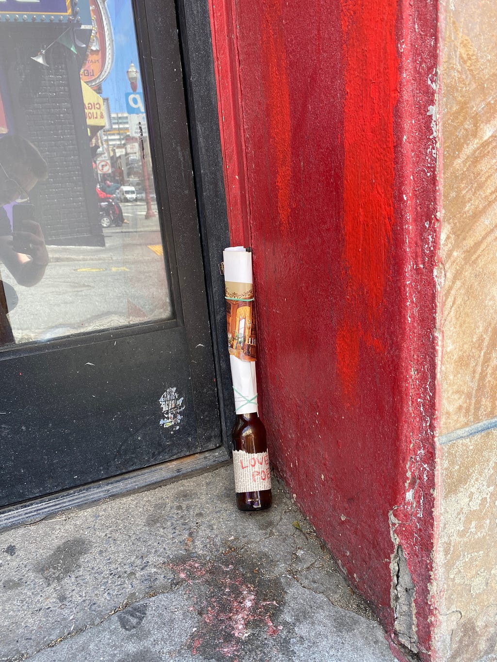 Love poem in bottle in red door frame