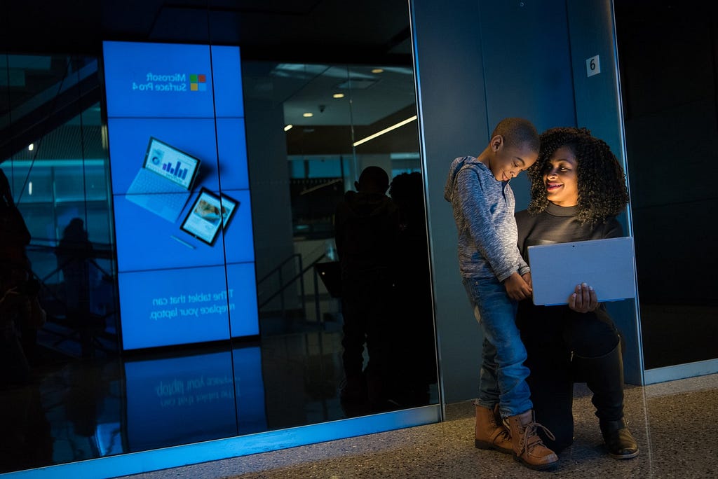 Black woman with a laptop and black boy