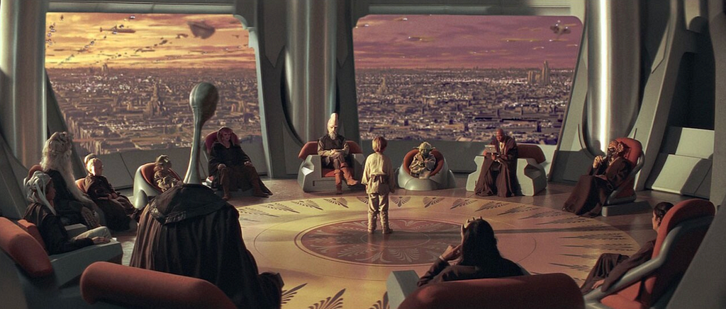 Anakin Skywalker meeting with the Jedi Council during The Phantom Menace. He is 9 years old and stands alone, isolated in the center of the room and surveilled from all sides by those who will choose whether to accept or deny him a place as a Jedi.