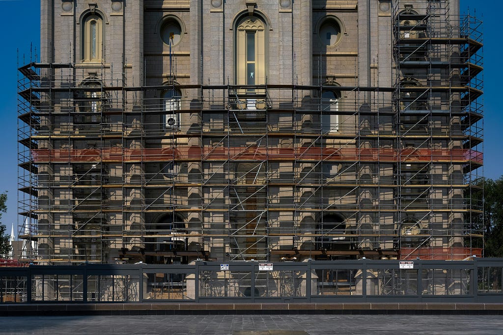Photo of a building with temporary scaffolding; by Rob Martin via Unsplash