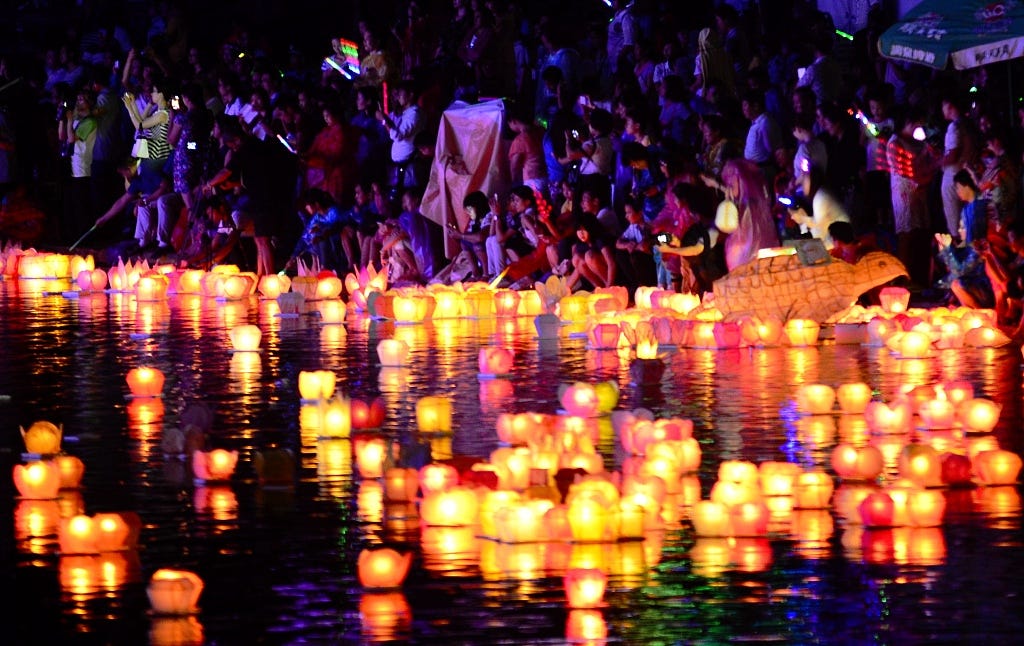 Lotus-shaped lanterns placed on the water for prayer during Ghost Month