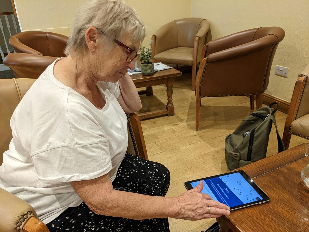 A woman carries out a usability test on her tablet in public place.