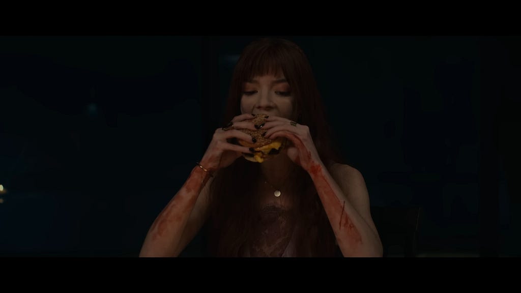Anya Taylor-Joy eats a cheeseburger