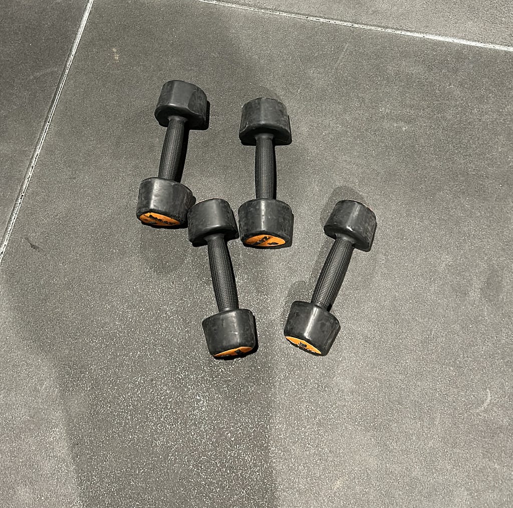 A bunch of dumbbells on the floor.