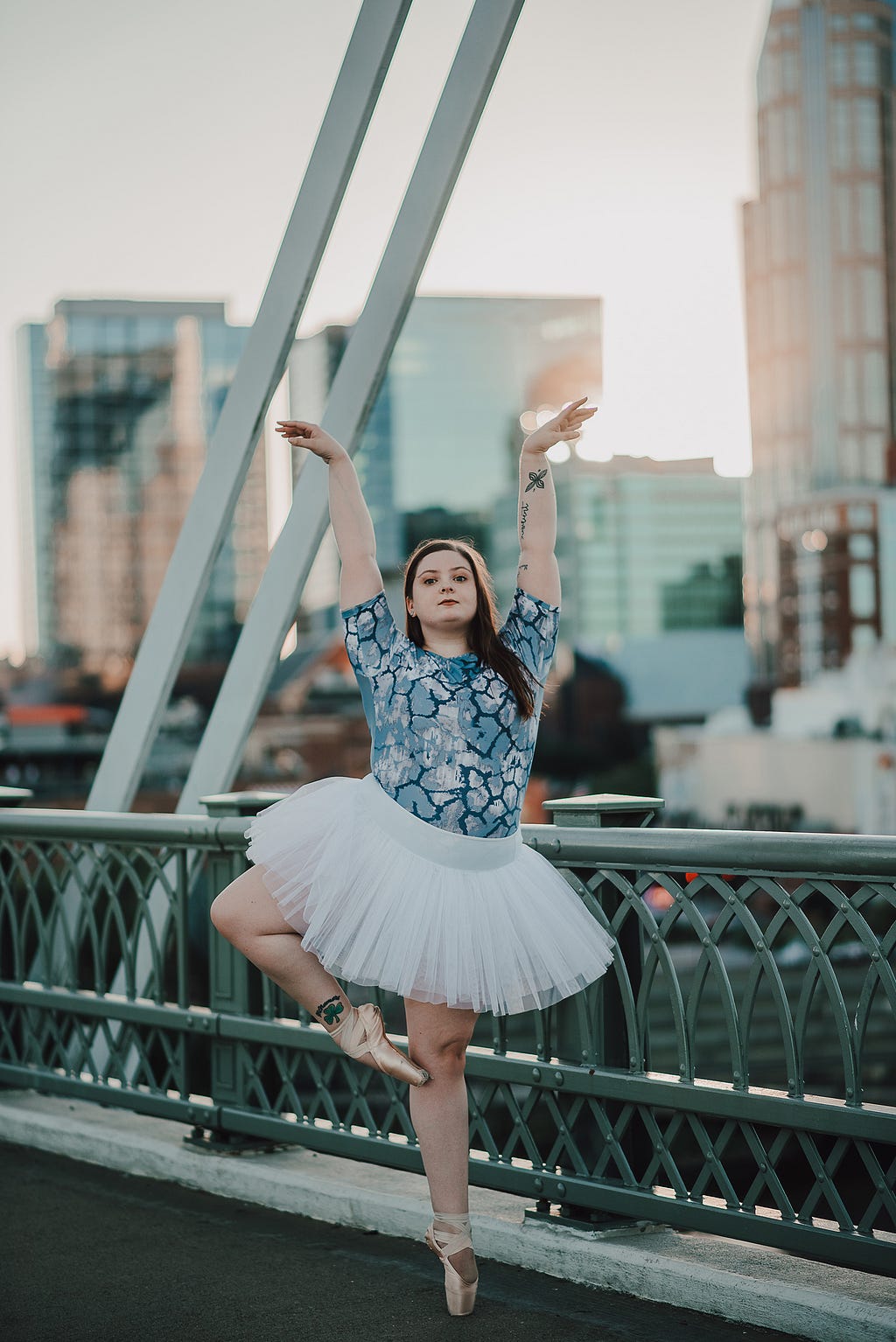 Ballerina posing outside on a bridge