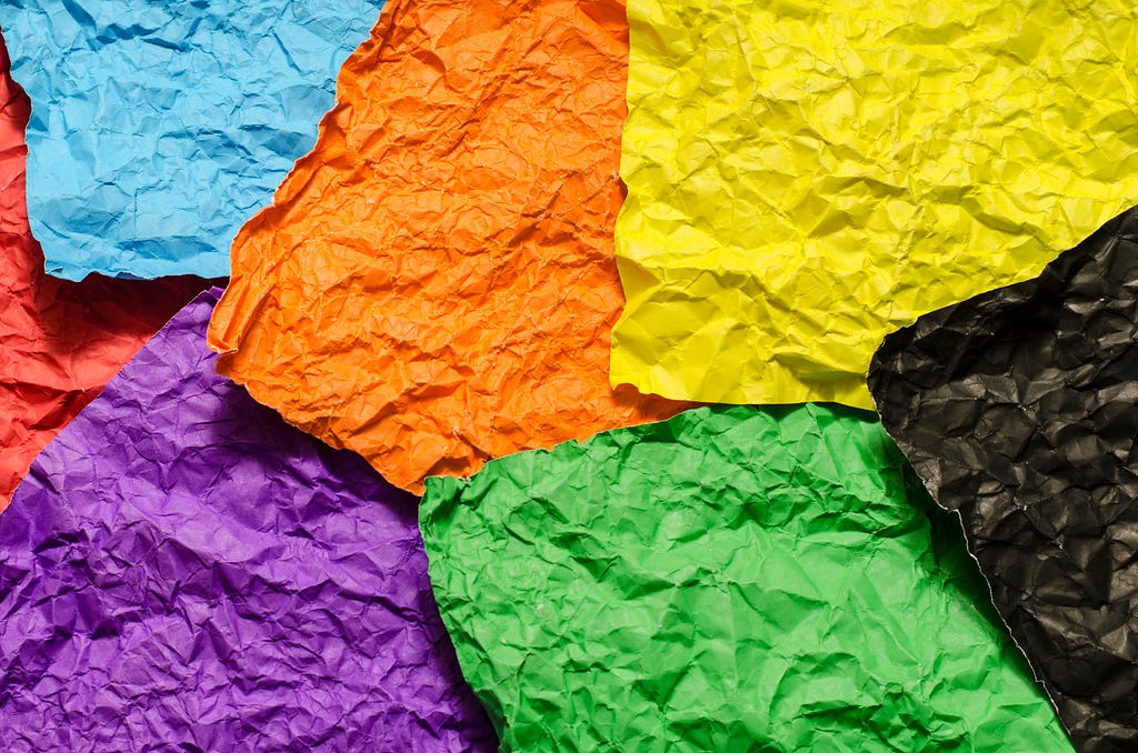 6 crumpled, blank post-it notes in different colours