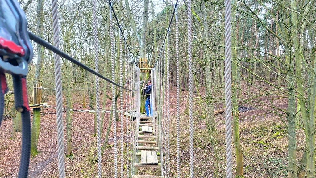 My husband, still smiling after I convinced him we needed to “Go Ape”. Photo by Laura Metze.