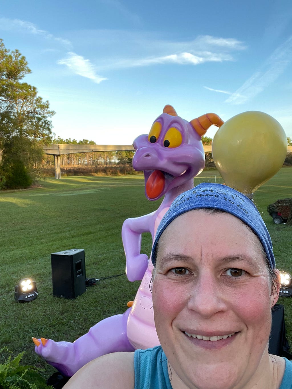 The author mid marathon with a purple dragon behind her.