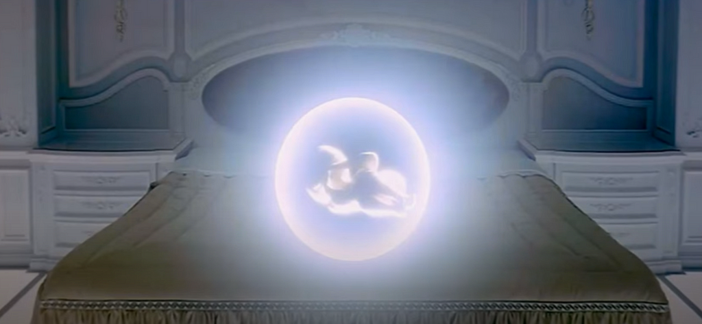 Caption from the final scene of 2001: A Space Odyssey in which the so-called “Star Child” figure overlaps with that of the bed