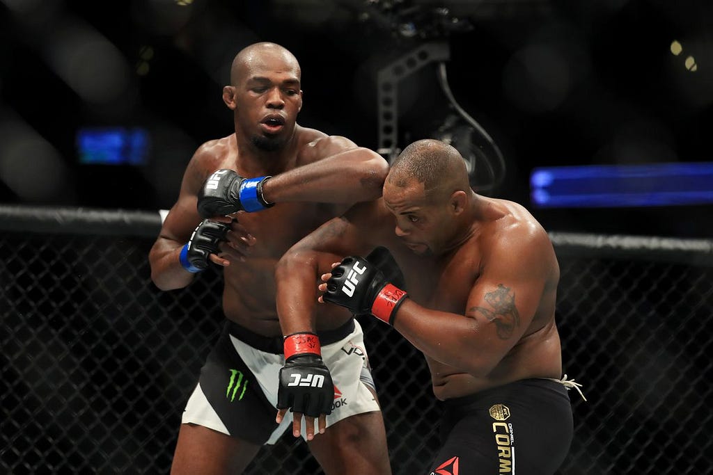 Jon Jones (left) landing his signature elbow on Daniel Cormier.