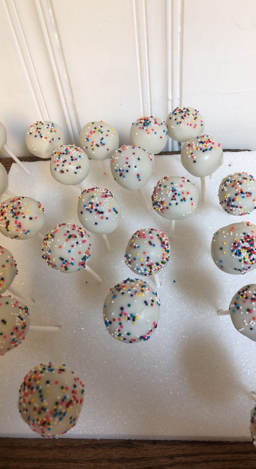 Cake-pops I made with vanilla almond bark and rainbow sprinkles.
