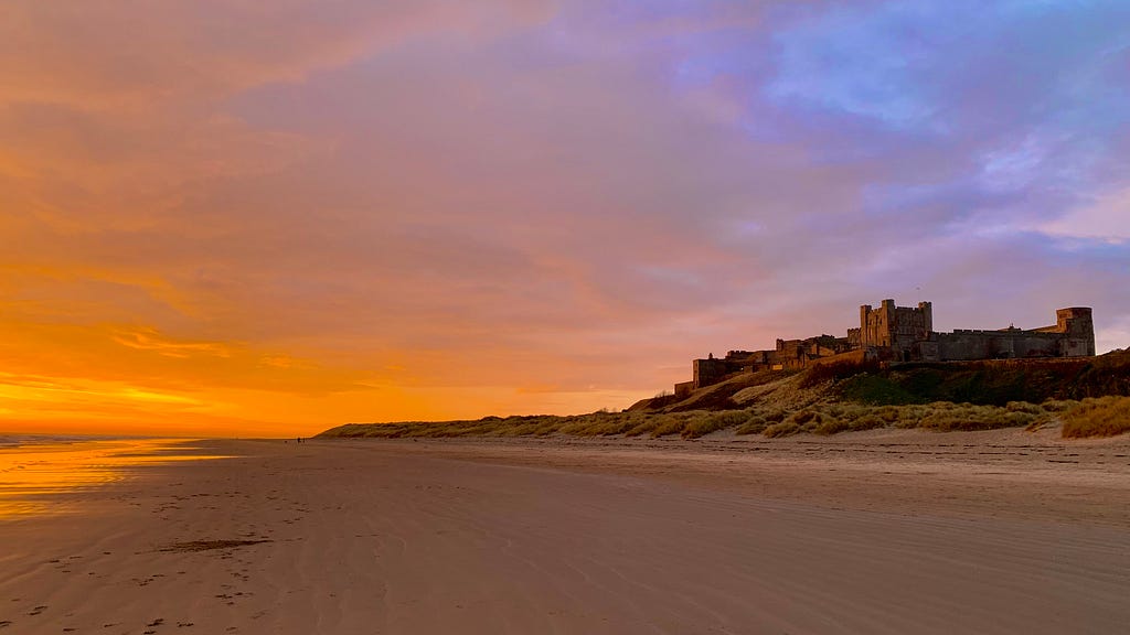 View of Bamburgh Castle, on the northeast coast of England, by the village of Bamburgh in Northumberland,