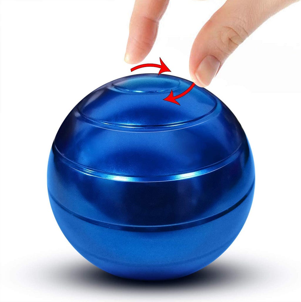 Blue metal ball with lines indicating where it spins. Red lines show the direction it spins, and fingers show scale.
