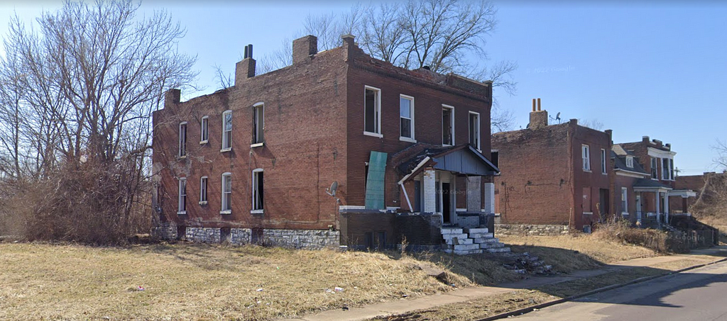 St. Louis Ave. multifamily home. Currently inhabited and needing major rehab.