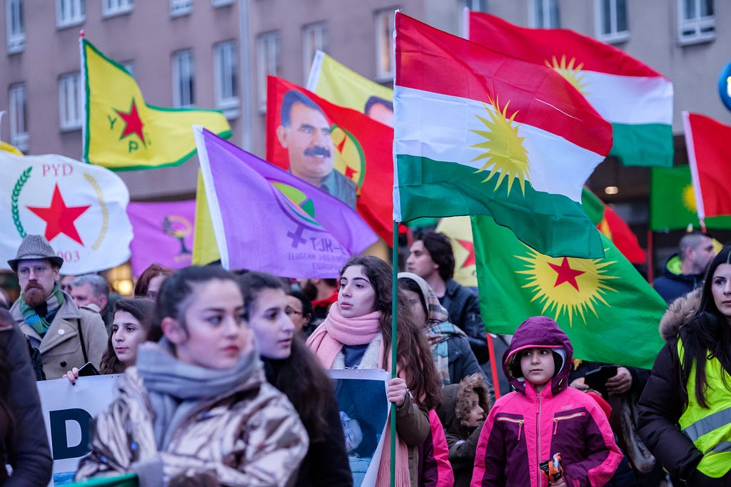 Thousands of people with flags protesting against the Turkish military forces’ attacks on Kurdish fighters and civilians in northern Syria. Photo by Magnus Persson/SOPA Images/LightRocket via Getty Images.