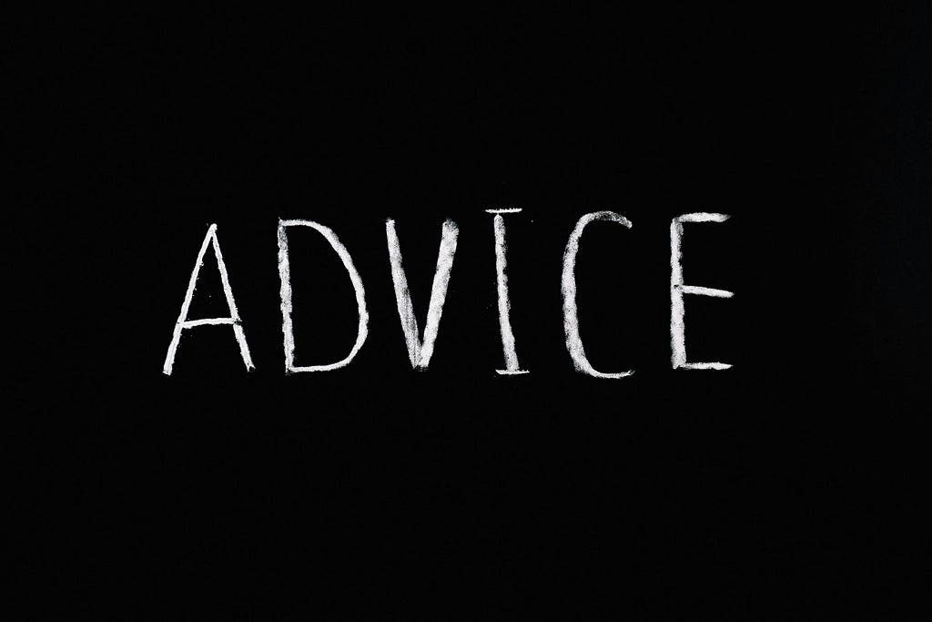 the word advice written in chalk on a black background