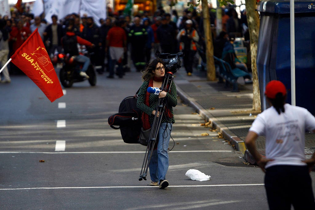 Picture by Hugo Ortuño. Montevideo, Uruguay. 2015. Patrícia Álvares covers the  national Union march on a strike day for EFE.
