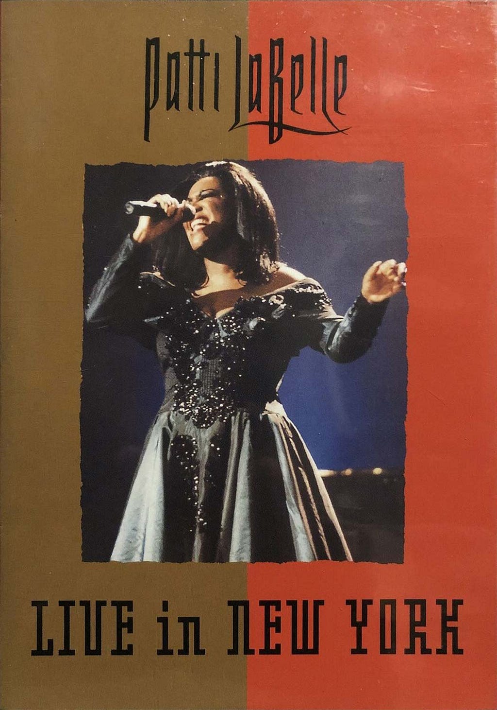 The cover of Patti LaBelle’s ‘Live in New York’ DVD shows LaBelle singing under stage lights in a pleated mini-dress that features a jeweled bodice and plunging neckline.