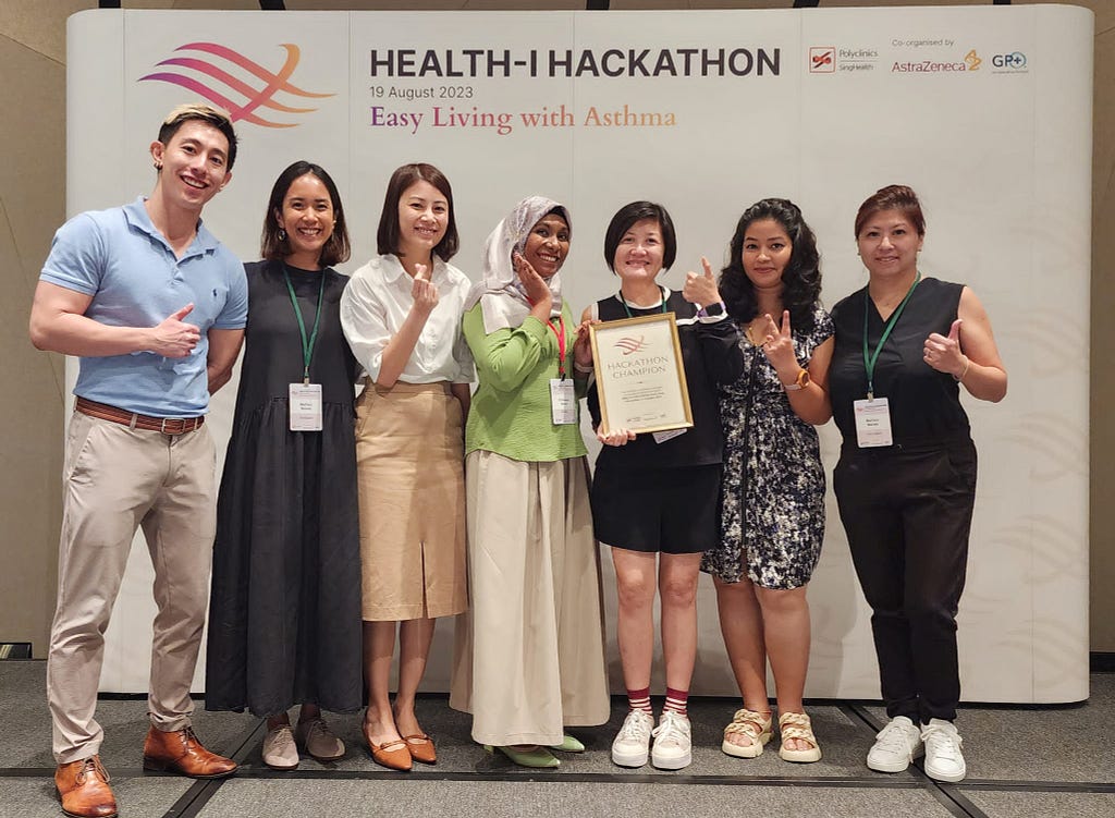 The hackathon winning team poses with their mentors during the awards ceremony.