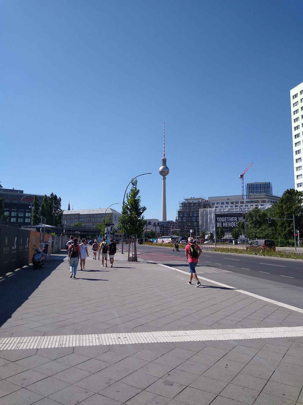 A snapshot of the road leading to Alexanderplatz (Berlin) with the famous TV Tower standing tall in the background.