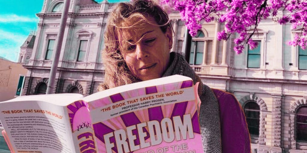 Woman reading the cornerstone book of the World Transformation Movement, ‘FREEDOM: The End Of The Human Condition’ by Australian Biologist Jeremy Griffith