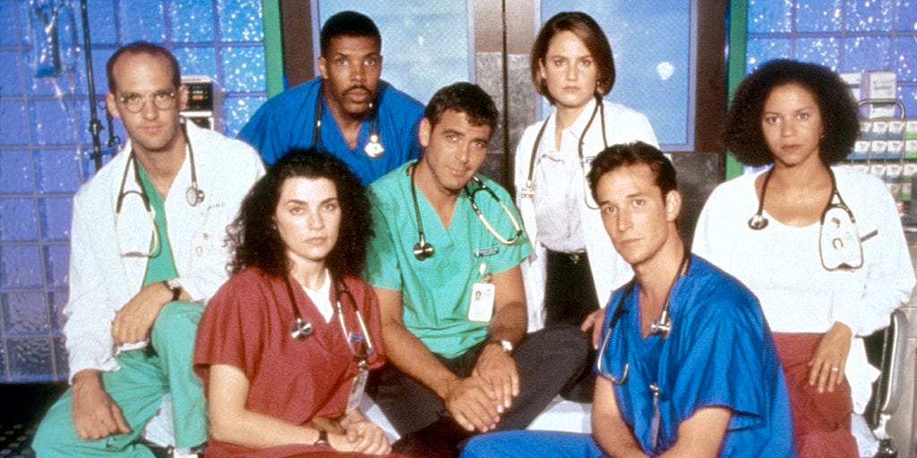 A group of doctors in scrubs posing for the camera