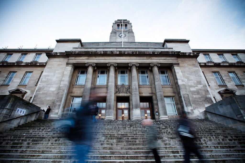 An image of the iconic Parkinson Building at the ‘front’ of the University of Leeds campus on Woodhouse Lane, taken from the steps leading up to the main entrance and with students moving back and forth in the foreground.
