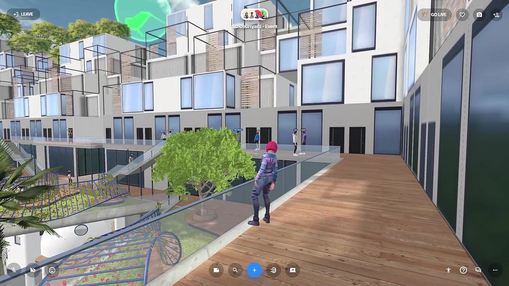 A dispersed group of human avatars standing around a raised walkway in an open courtyard in a city block in a virtual reality scene.