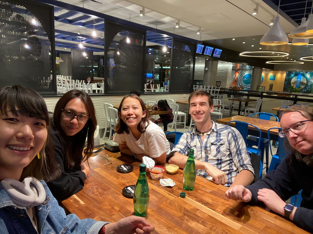 A group photo of the HENNGE team post-flights. The author is in the center and looks tired.