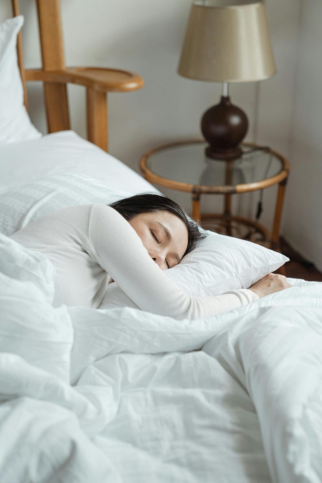 image of woman looking very comfortable asleep in her bed