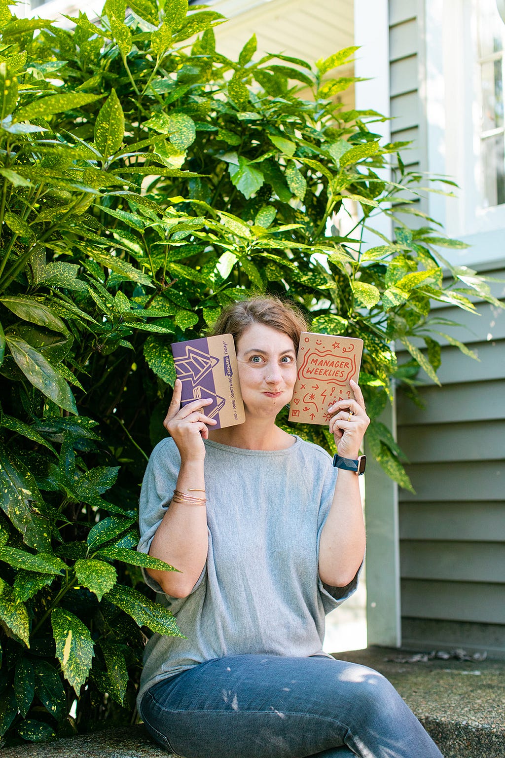 Jen Dary, author of the piece, holds up a Plucky product called Manager Weeklies.