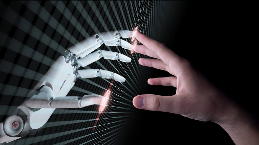 A human hand touching a robot’s hand.