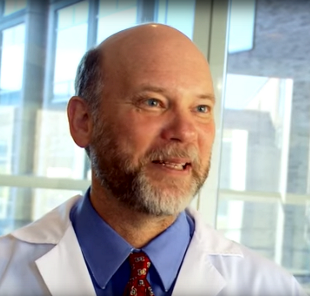 Neuroscientist Dr. Jay Giedd standing in front of a window in the hospital.