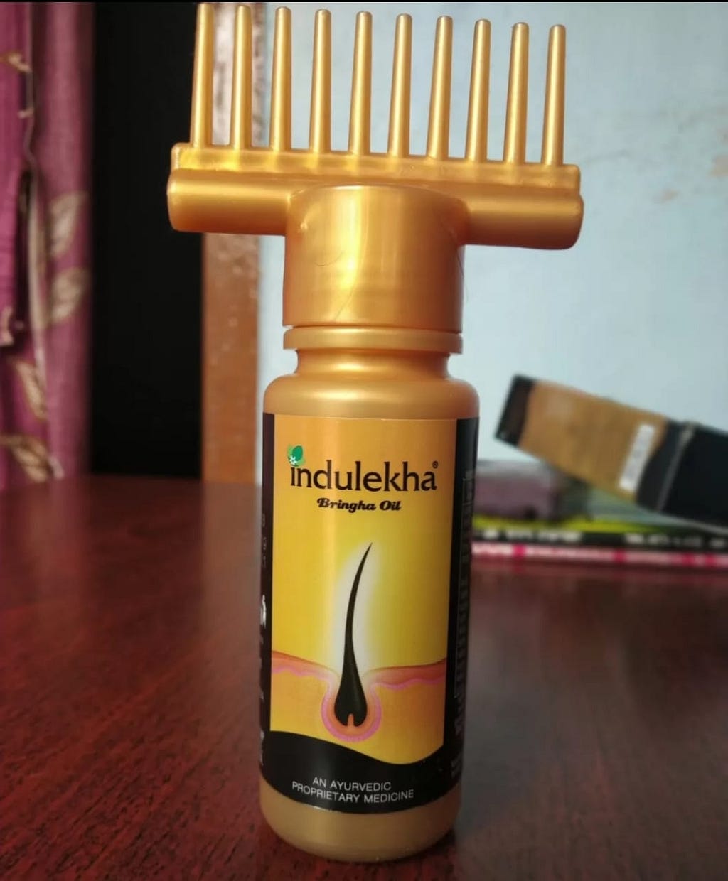 a bottle of indulekha bringha hair oil.