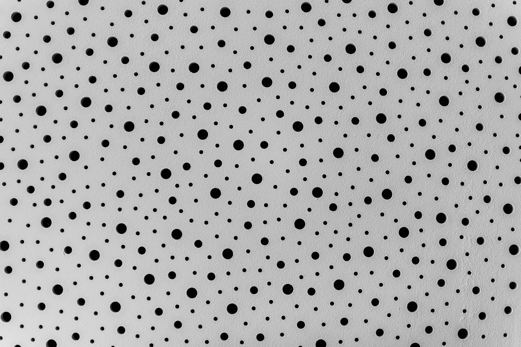 Many black ink dots on a white page