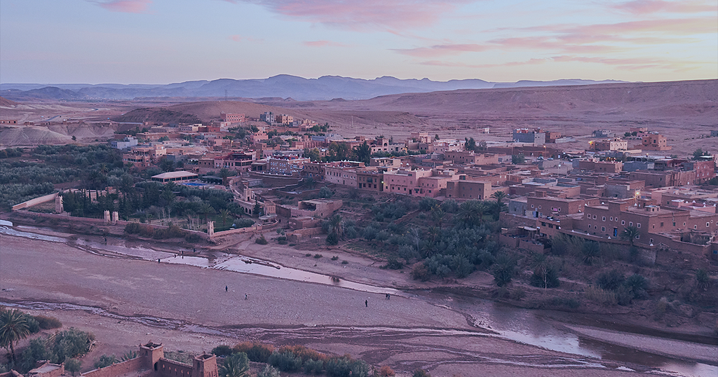 Image shows a picture of Marrakesh in Morocco with a river with very low flow