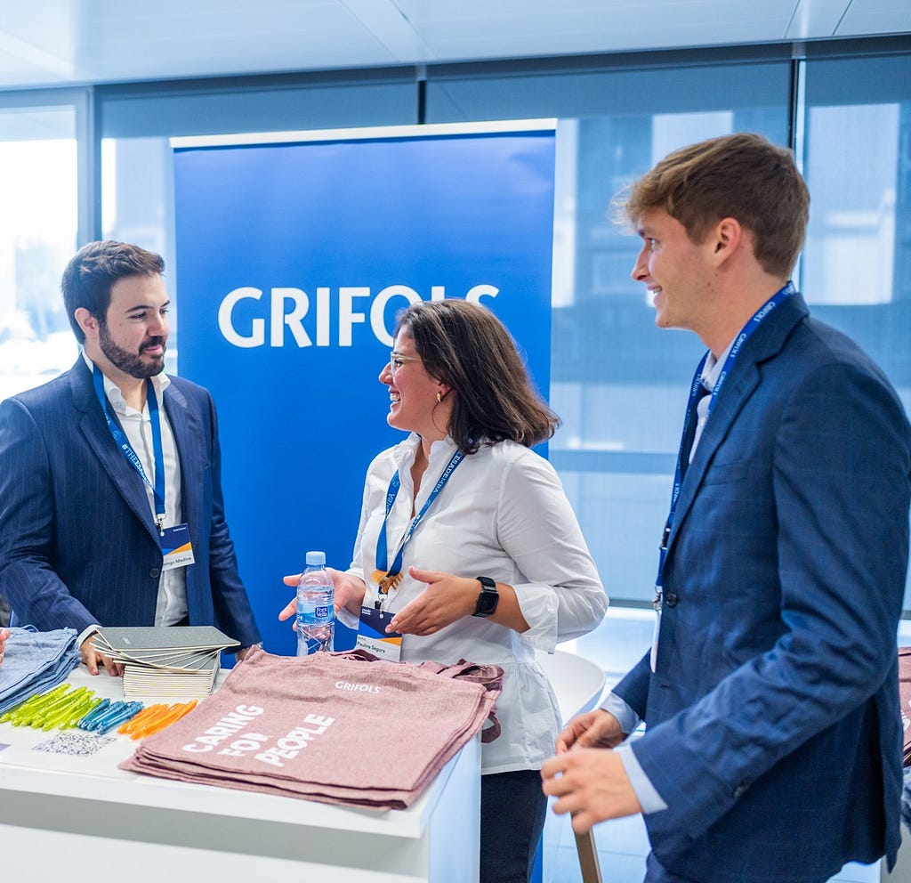 A photo taken at a Grifols event, featuring representatives meeting with students from Esade Business School