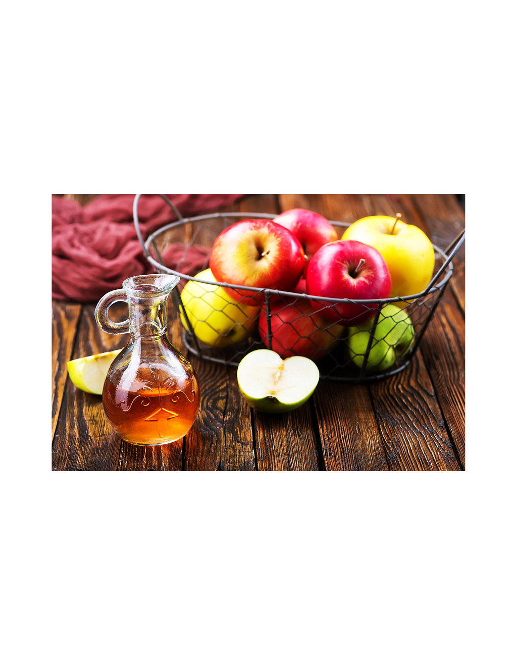 Apples and apple cider vinegar on a wooden table