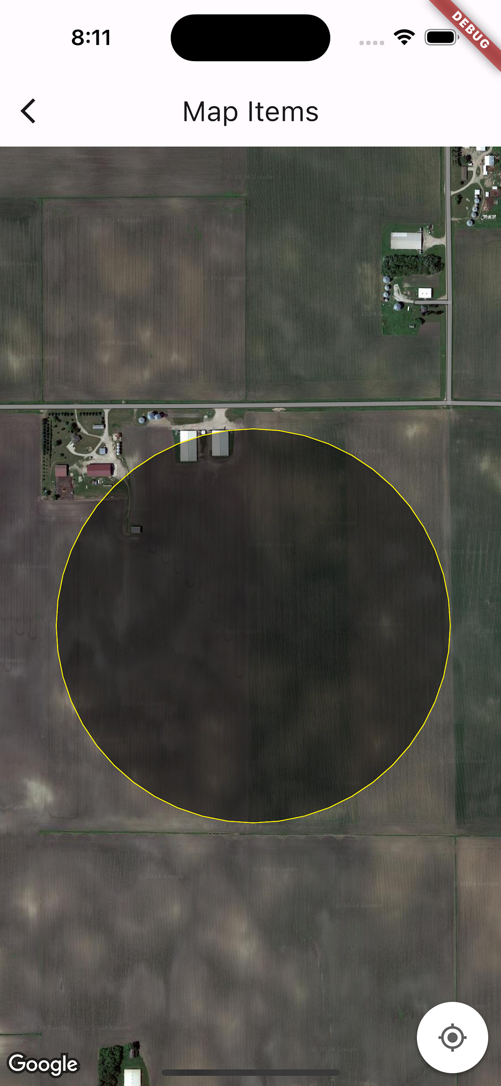 A screenshot of a map open on a smartphone. The map is showing satellite image of a farm in Northern part of USA. A circle is drawn on the map, the colour of the circle is yellow and it is filled with translucent black color.