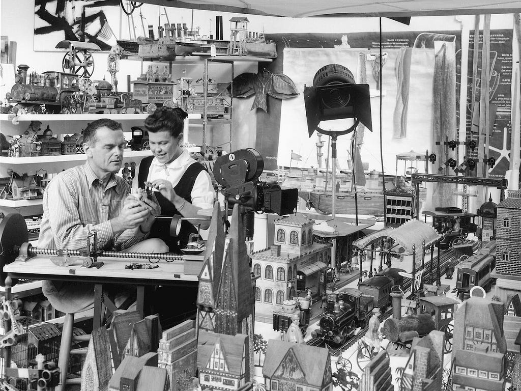 Designers Charles and Ray Eames filming in their studio for their 1957 short film, Toccata for Toy Trains.