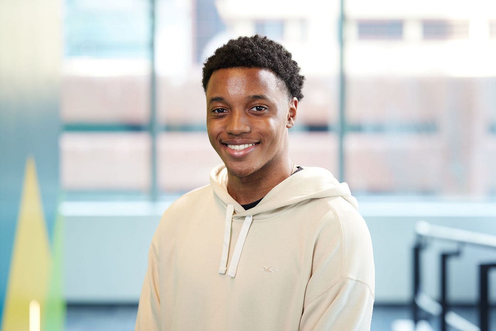 Zacharie Verdieu smiles at the camera.